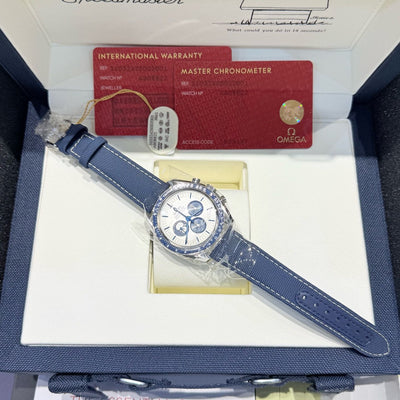 Omega watch with blue strap in a box with warranty card