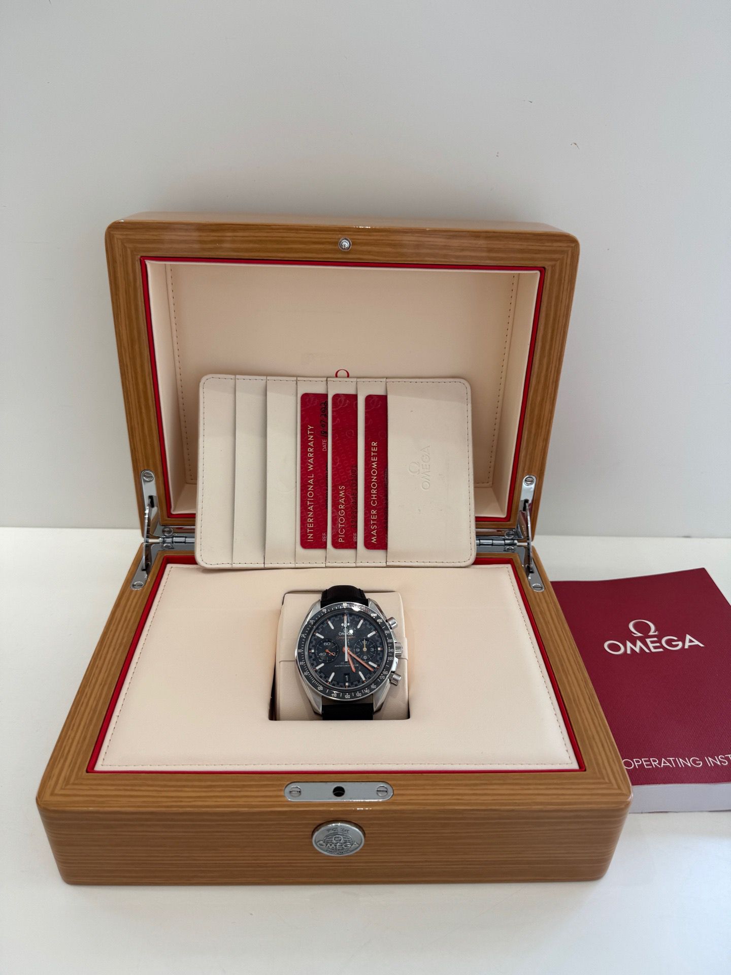 Omega watch in a wooden box with a white background