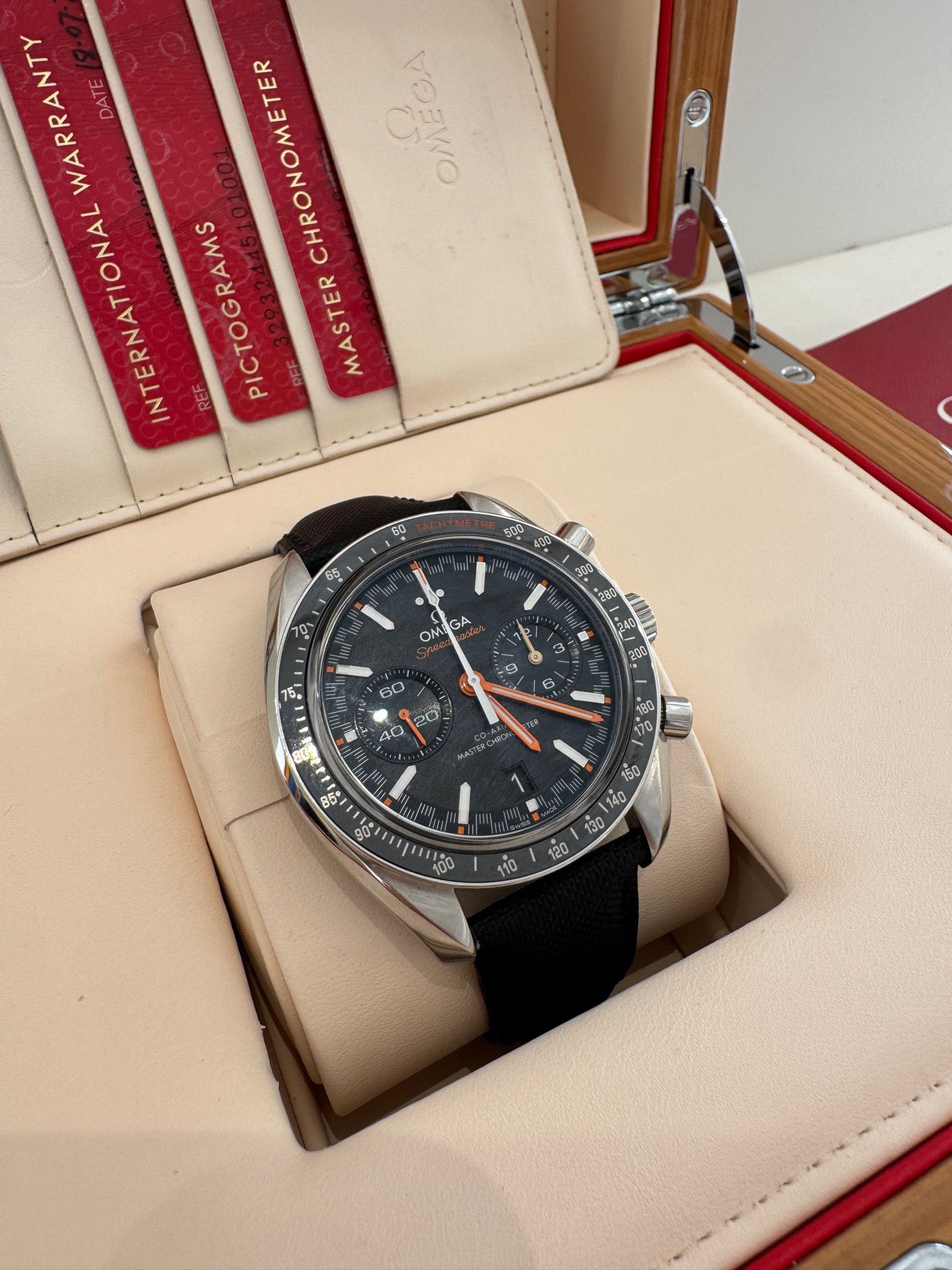 Omega watch in a display case with red and beige interior